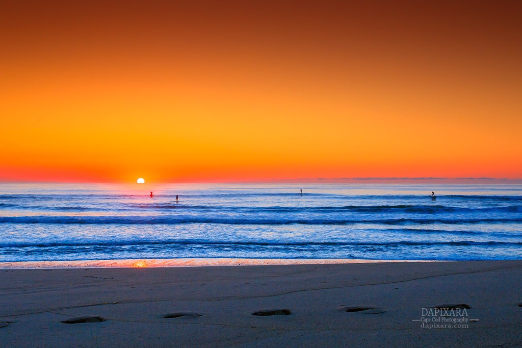 Paddling in to Sunrise. A spectacular Ocean sunrise behind a stand up paddlers in Cape Cod. Dapixara photography.