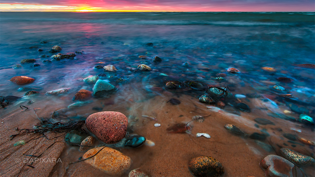 Sunset on a pebbly beach. Long exposure beach photo by Dapixara