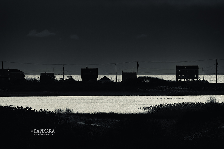 The Truro, Massachusetts houses was silhouetted against Cape Cod Bay. black-and-white photo by Cape Cod photographer Dapixara.