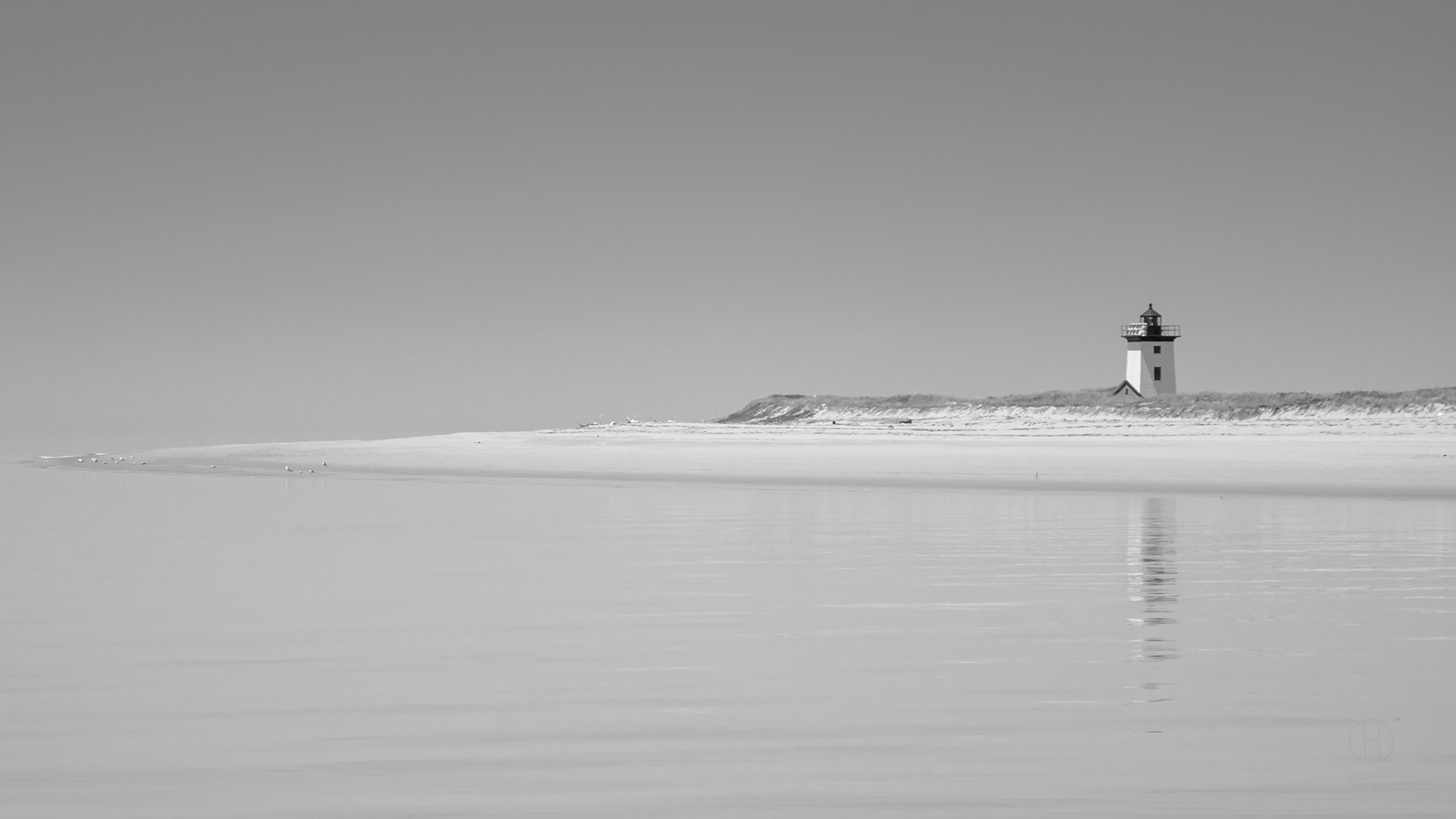 Black and white Isolated Lighthouse. Cape Cod beach, Provincetown, Massachusetts.