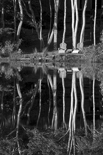 Black and White Landscape with two chairs on Cape Cod pond.