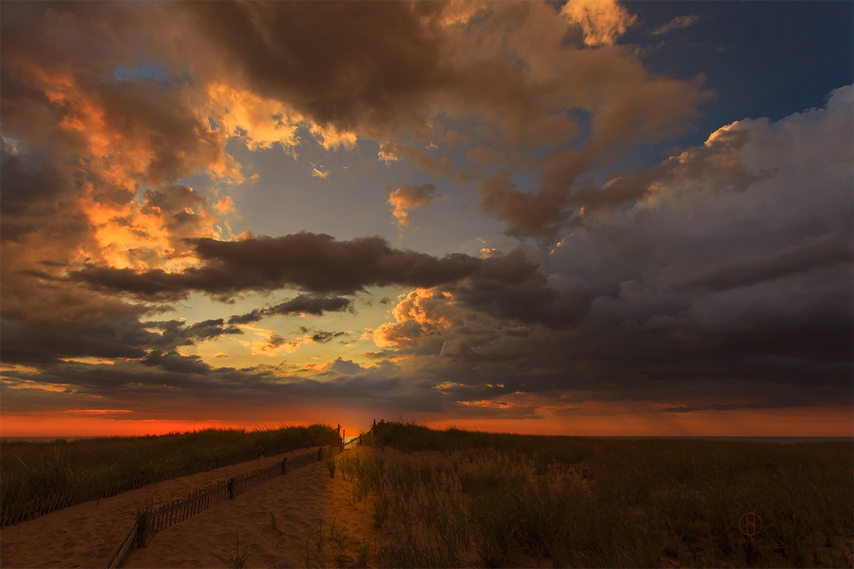 Description: Dramatic clouds break up over Atlantic Ocean. Stunning sunrise over Nauset beach, Cape Cod. Photographer Dapixara 2014.