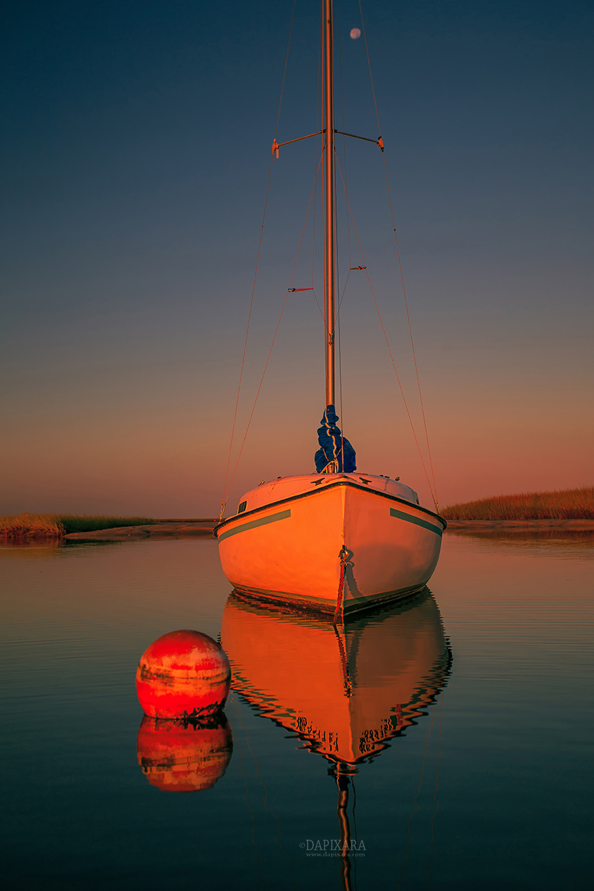 Red Sunrise Reflections On Sailboat. Cape Cod seascape photography for sale by photographer Dapixara. 